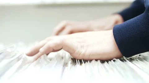 A Man eagerly browses through a selection of vintage records 動画素材 74849985