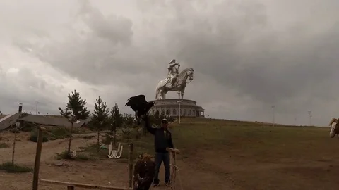 Man with an eagle near the statue of Genghis Khan Stock Footage 81811357