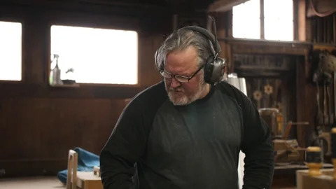 Man with ear protection working with machine in shop Stock Footage 102045003