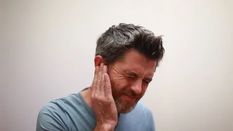 Man with earache is holding his aching ear body pain concept Stock Footage 96215461