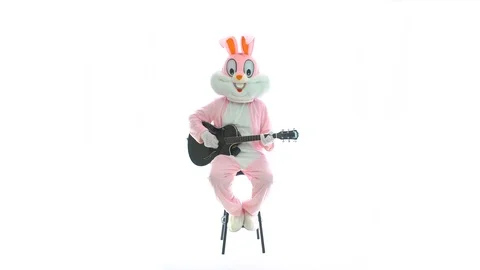 Man in easter bunny costume plays music on guitar, celebrates easter, have fun Video stock 107390359