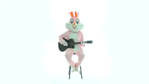 Man in easter bunny costume plays music on guitar, celebrates easter, have fun Stock Footage 107425198