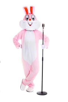 Man in a easter bunny costume with retro microphone, sings, have fun on white Stock Photos