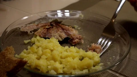 Man eates potatoes. Boiled potatoes. Mackerel Stock Footage 87598509