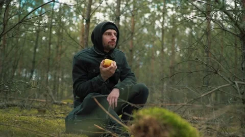 Man eating an apple in the forest Stock Footage 191841097