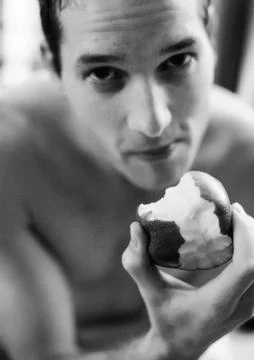 Man eating apple, looking at camera, b&amp;w Stock Photos