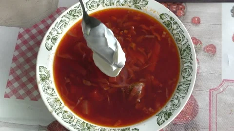 Man eating beetroot soup with sour cream Stock Footage 160260596