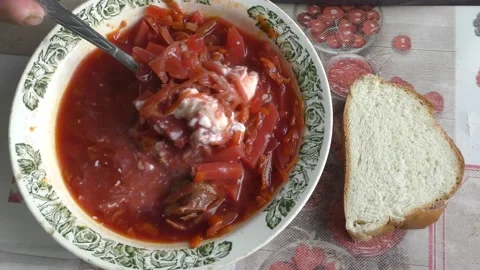 Man eating beetroot soup with sour cream Stock Footage 160261152