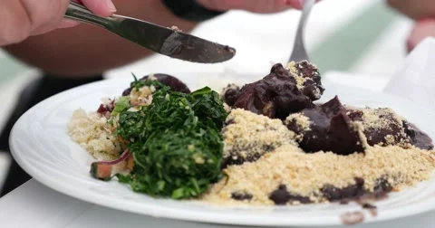 Man eating Brazilian Feijoada Stock-Footage 63653175