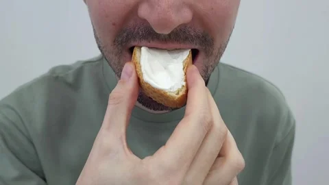 Man eating bread with cream cheese. Close-up of hands and food. Stock Footage 284043621