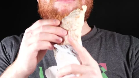 Man eating burrito Stock Footage 257697535