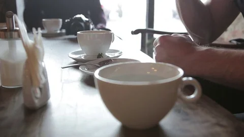 Man eating cake and drinking tea in a cafe in the city. Stock Footage 71347317