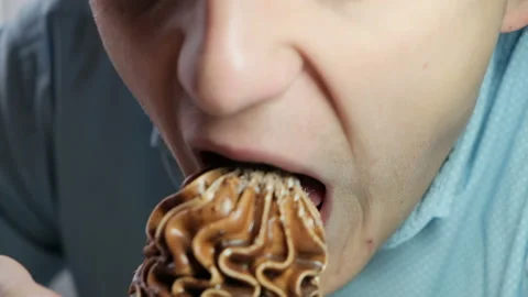 Man eating cake or ice cream, close-up Stock Footage 120699540