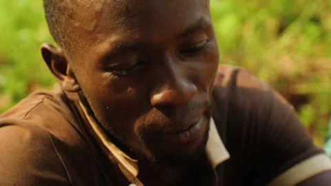 A man eating, chewing termites. Stock-Footage 201371584