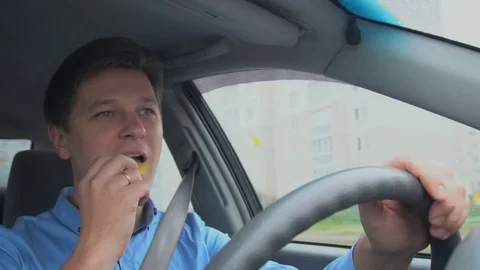 A man is eating chips in the car. Stock Footage 81835465