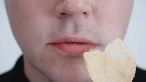 The man is eating chips. Close-up. Stock Footage 147921653
