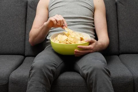 Man eating chips Stock Photos