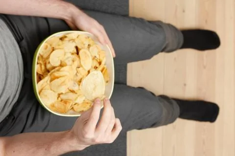 Man eating chips Stock Photos