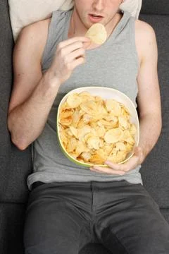 Man eating chips Stock Photos