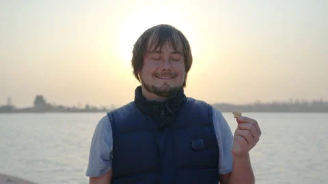 Man eating cracker at sunset. Stock Footage 135146159