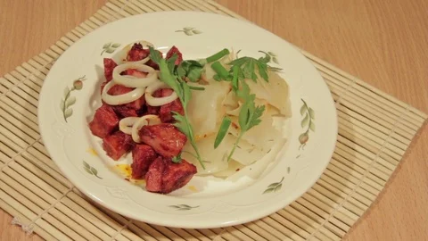 Man eating dish of cabbage with roasted meat Stock Footage 70925944