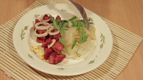 Man eating dish of cabbage with roasted meat Stock Footage 70926377