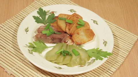 Man eating dish of potatoes with roasted meat Stock Footage 70925971