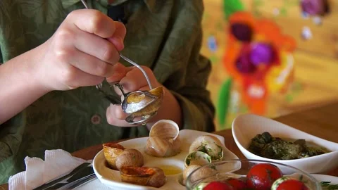 Man eating a dish of snails Stock Footage 139384476