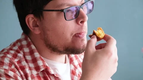 Man eating Easter cake and drinking coffee on dinner table Stock Footage 303634979