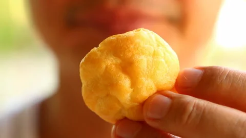 Man eating éclair bread , outdoor  Chiangmai Thailand Stock Footage 131013837