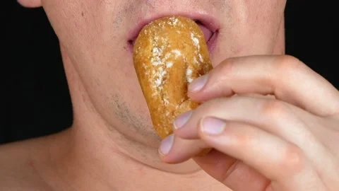Man eating an Eclair.One eats cake with condensed milk.Choux pastry cream. Stock-Footage 133223747