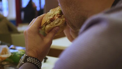 Man eating fast food close-up, Burger and fries. Stock Footage
