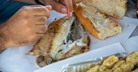 Man eating fish Stock Photos