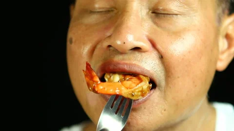 Man eating  Fried  prawn  , in studio  Chiangmai  Thailand Stock Footage 139332620