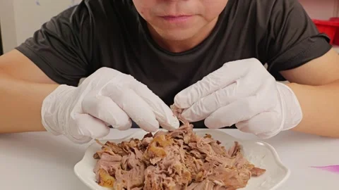 Man eating hand‑torn marinated beef. Stock Footage 343604451