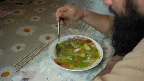 A man eating homemade peruvian Minestrone soup Stock Footage 140128811