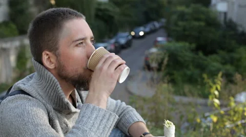 Man eating kebab and drinking coffee Stock Footage 67613863