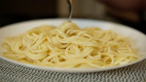 A man eating pasta while sitting at the kitchen table, close-up Stock Footage 132575210