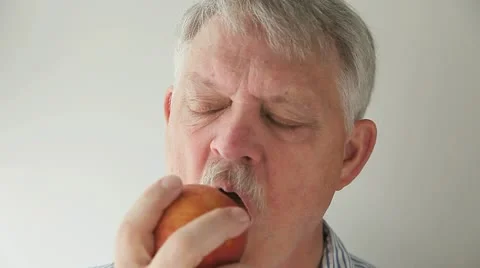 Man eating a peach Stock Footage 22356759