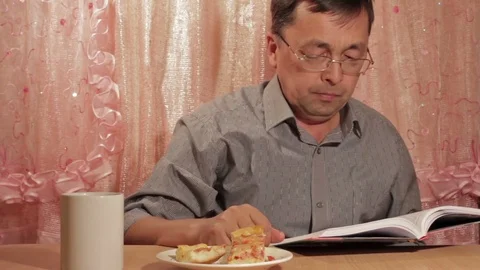 Man eating pie at home Stock Footage 69723505