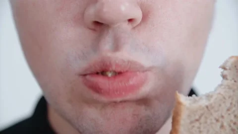 The man is eating a piece of bread. Close-up. Stock Footage 146265478