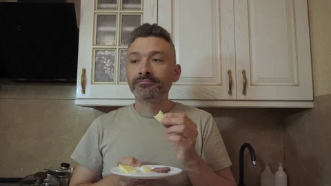 Man eating from plate with hand Stock Footage 341832873