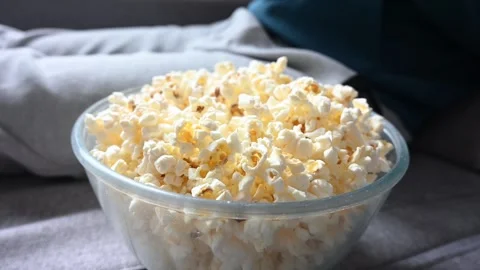 Man eating popcorn on the sofa Stock Footage 307604256