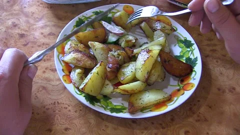 A man is eating a potato dish Stock Footage 106450993