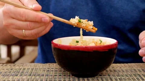 Man eating rice with vegetables in a chinese reastaurant Stock Footage 91982995