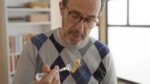 Man eating salad with fork, lips touching food while holding plastic contai.. Stock Footage 337443567