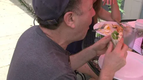 Man eating a sandwich wrap (2 of 2) Stock Footage