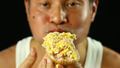 Man is eating scrambled eggs with bread, , in studio   Chiangmai Thailand Stock Footage 166391204