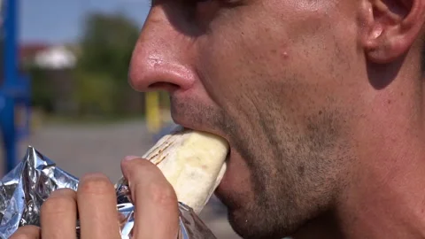 Man eating shawarma Stock Footage 284619390