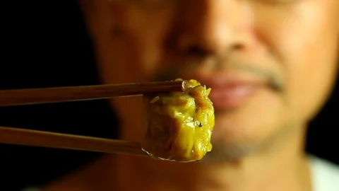 Man eating shrimp dumpling ,in studio  Chiangmai Thailand Stock Footage 118648847